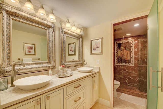 bathroom with double vanity, toilet, a stall shower, and a sink