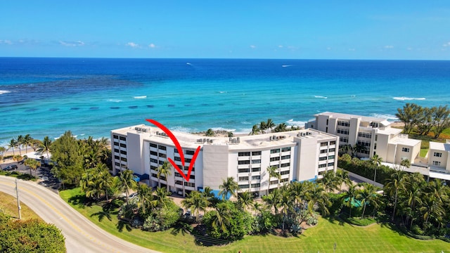 birds eye view of property with a beach view and a water view