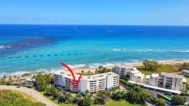 bird's eye view featuring a view of the beach and a water view