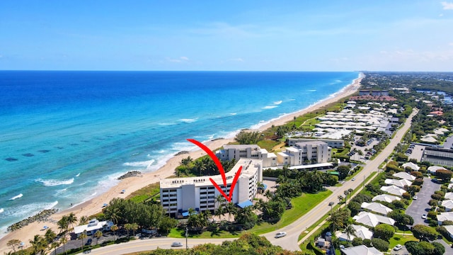 birds eye view of property with a beach view and a water view