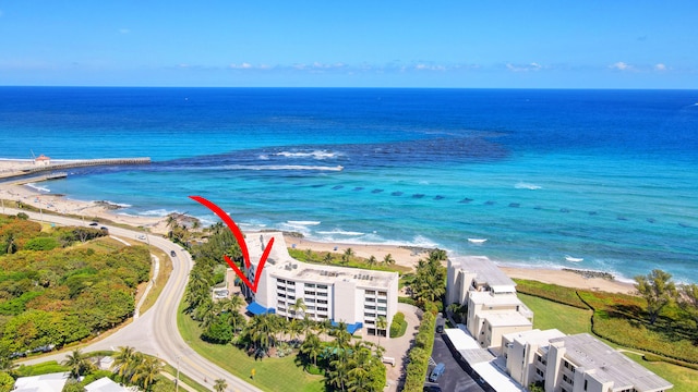 birds eye view of property featuring a water view and a view of the beach