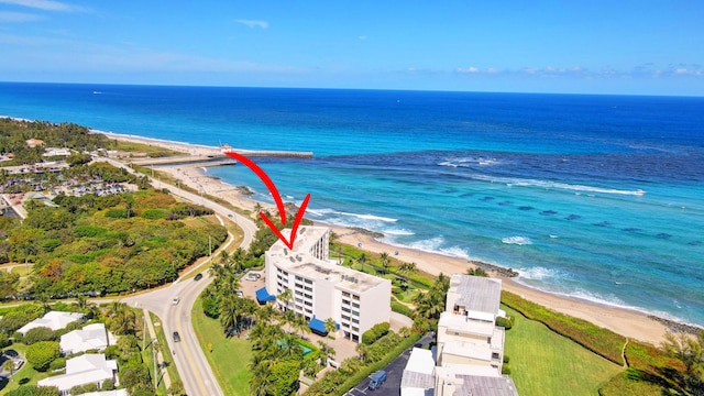 drone / aerial view with a water view and a beach view