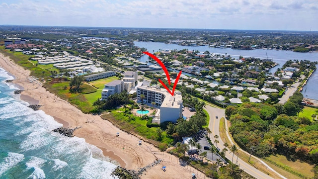 bird's eye view with a water view and a view of the beach