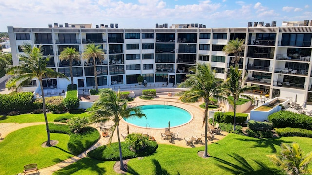 view of swimming pool with a yard and a patio