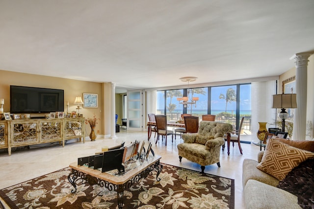 living room featuring ornate columns and floor to ceiling windows