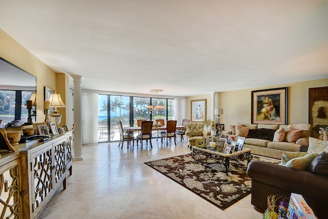 living room featuring ornate columns and floor to ceiling windows