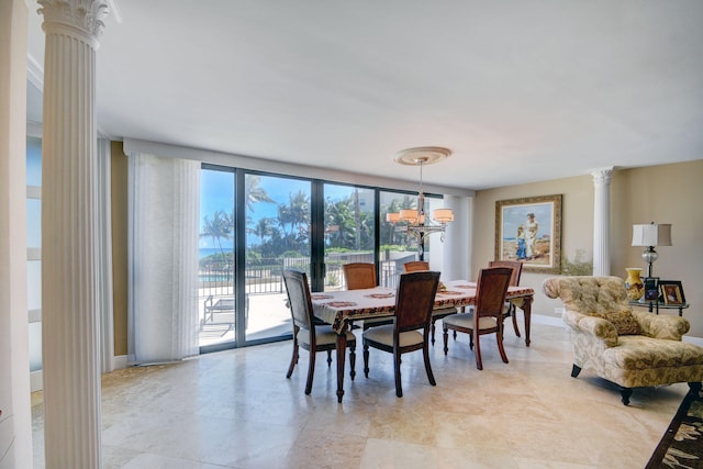 dining space with a wall of windows, a chandelier, and decorative columns