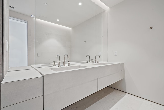 bathroom with double vanity and tile flooring