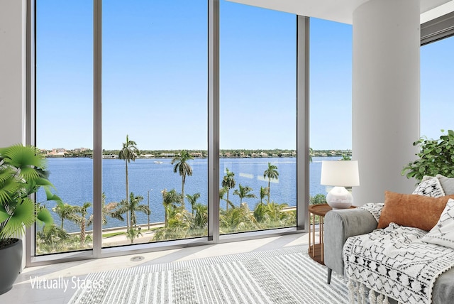 unfurnished sunroom featuring plenty of natural light and a water view