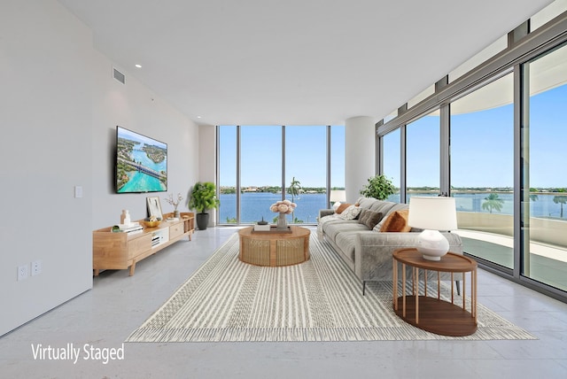 living room with floor to ceiling windows and a water view