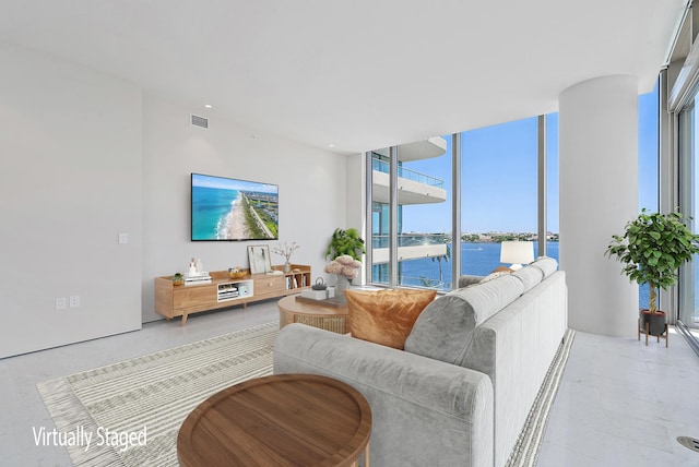 living room featuring a water view and a wall of windows