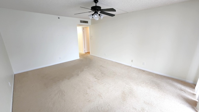 empty room with ceiling fan and light colored carpet