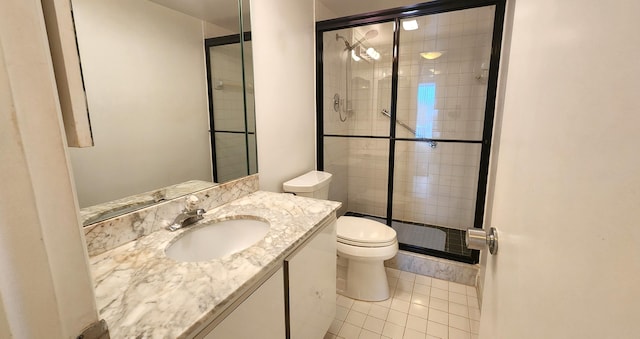 bathroom with toilet, vanity, tile patterned floors, and an enclosed shower