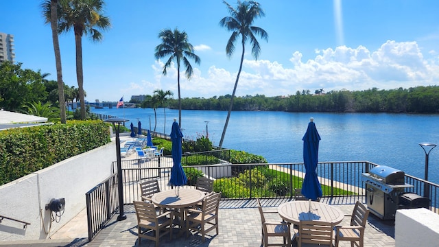 view of patio featuring a grill and a water view