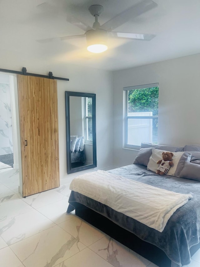 bedroom with a barn door, ceiling fan, and light tile floors