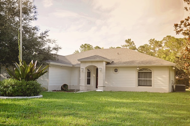 ranch-style house featuring central AC and a front yard