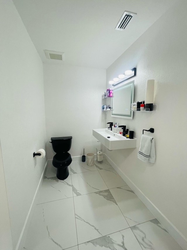 bathroom with tile floors and sink