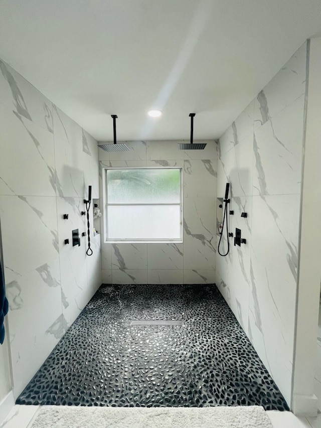 bathroom featuring a tile shower and tile flooring