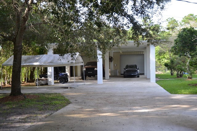 view of front of property with a carport and a garage