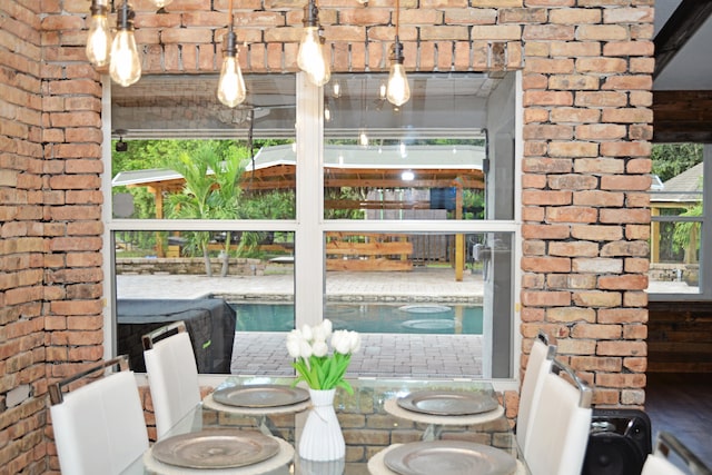 interior space featuring brick wall and a healthy amount of sunlight