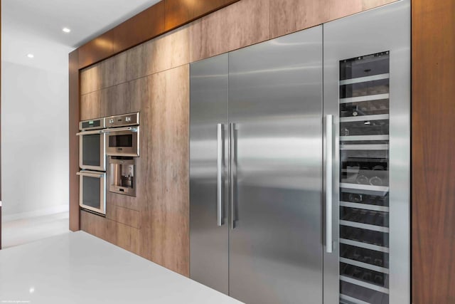 kitchen with sink, ceiling fan, a breakfast bar area, hanging light fixtures, and island range hood