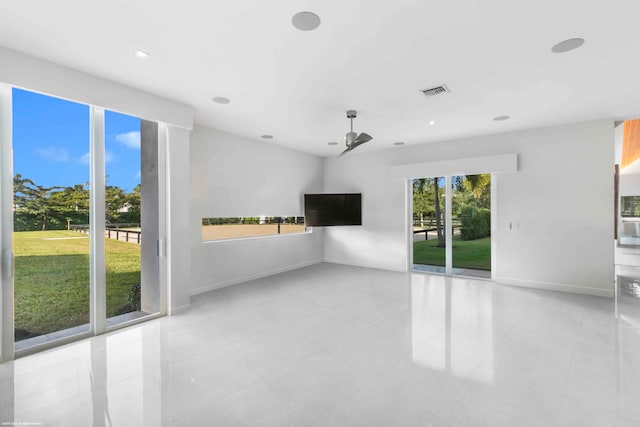 living room with ceiling fan and light tile patterned floors