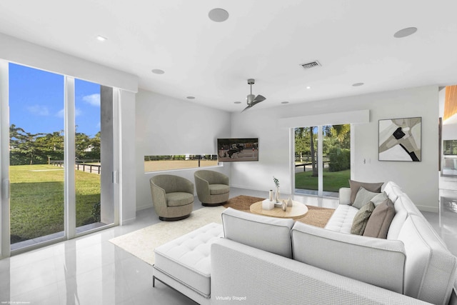 unfurnished living room featuring light tile patterned flooring and ceiling fan