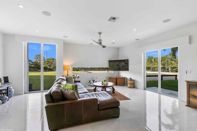 living room with ceiling fan and light tile patterned flooring