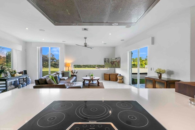 living room featuring light tile patterned floors and ceiling fan