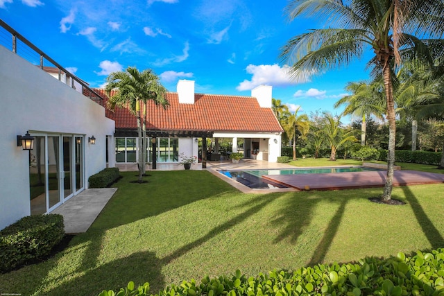 view of swimming pool featuring a patio area and a yard