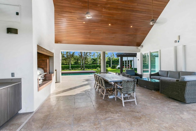 view of patio / terrace featuring an outdoor living space with a fireplace and a grill