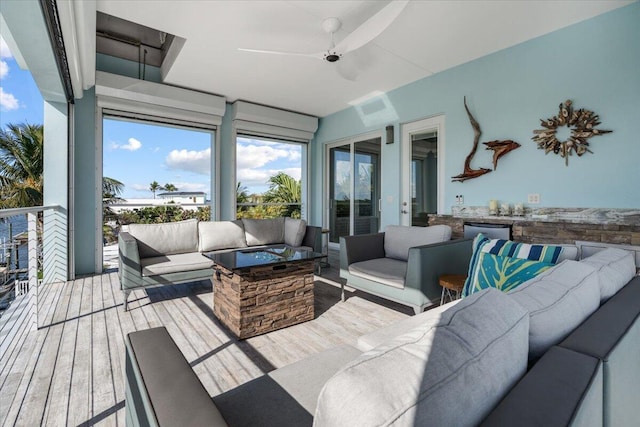 sunroom / solarium featuring ceiling fan