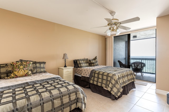 tiled bedroom featuring access to outside, ceiling fan, and a water view