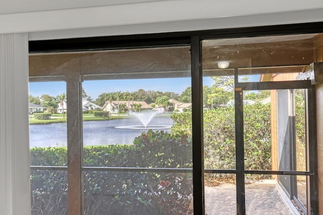 interior space featuring plenty of natural light and a water view