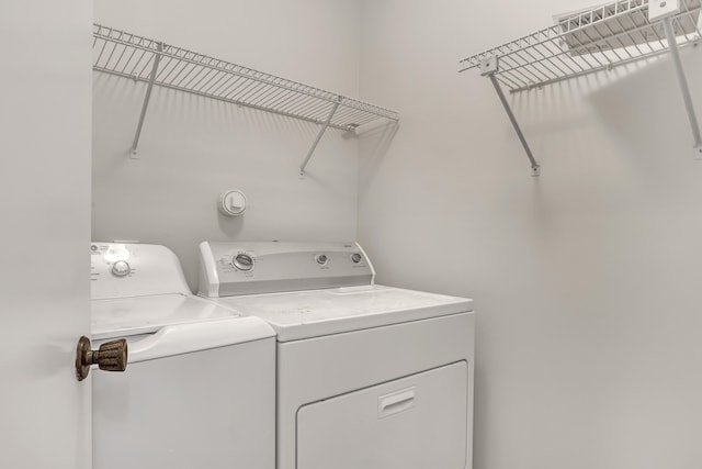 clothes washing area featuring washing machine and clothes dryer