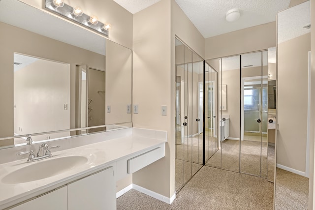 bathroom with vanity and a textured ceiling