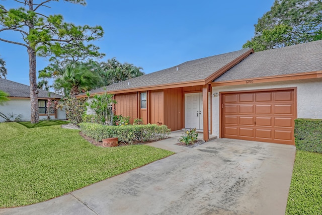 ranch-style home with a front yard and a garage