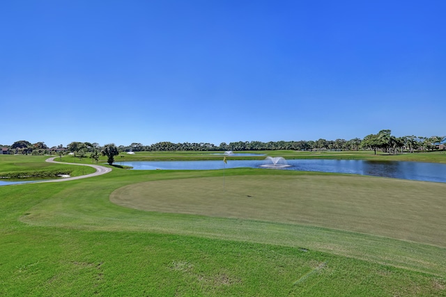 surrounding community featuring a lawn and a water view