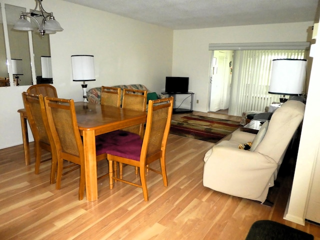 dining room featuring a notable chandelier and light hardwood / wood-style flooring