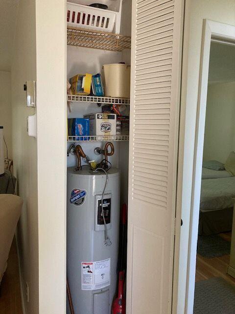 utility room with electric water heater