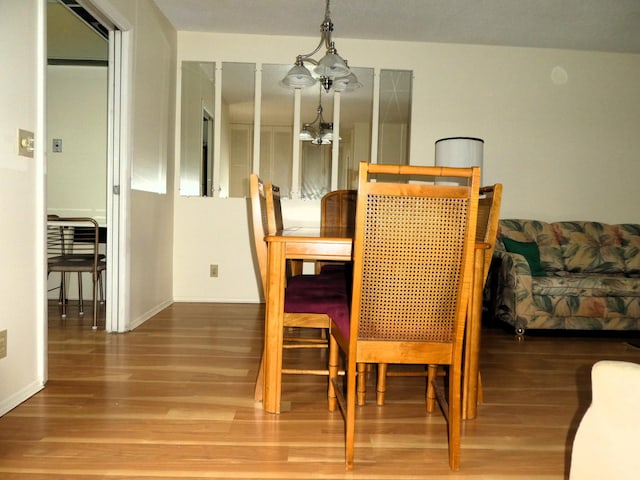 dining space featuring a chandelier and hardwood / wood-style floors