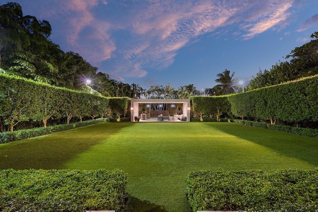 yard at dusk featuring a patio