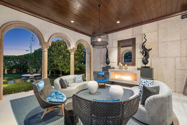 patio terrace at dusk featuring an outdoor living space with a fireplace