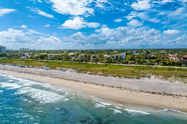 birds eye view of property featuring a water view and a view of the beach