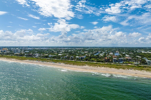 drone / aerial view featuring a water view and a view of the beach