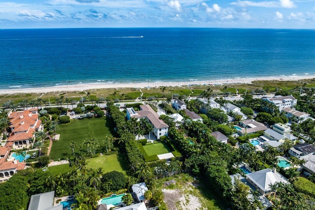 birds eye view of property featuring a water view and a beach view