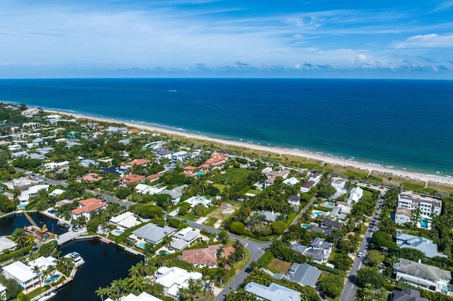 aerial view with a water view and a beach view