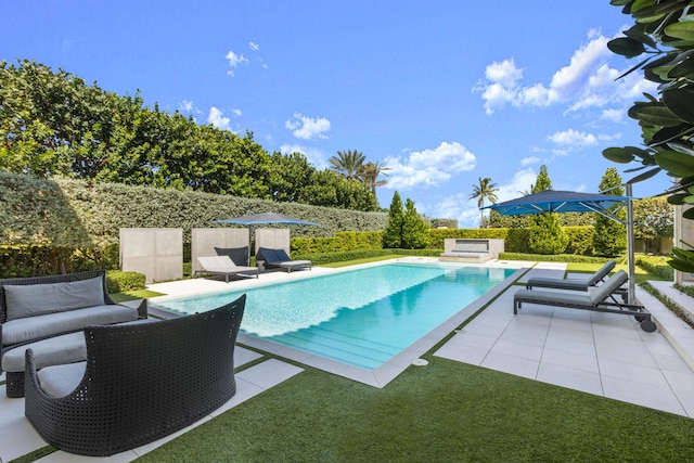 view of swimming pool featuring a patio area, a lawn, and outdoor lounge area