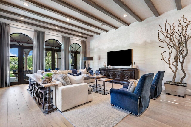 living room with light hardwood / wood-style floors, french doors, and beam ceiling