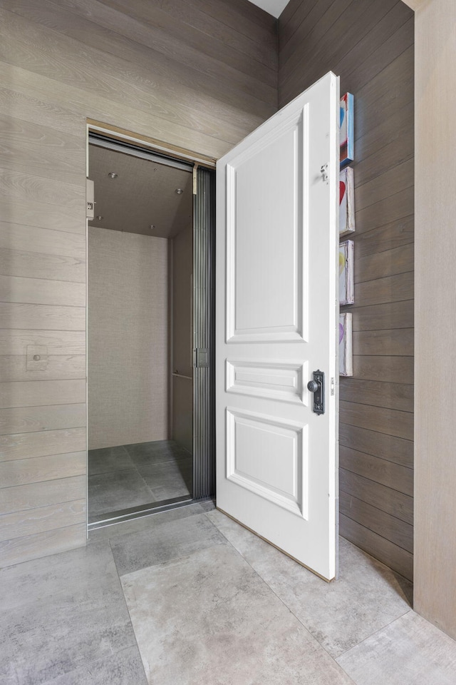 interior space featuring wood walls